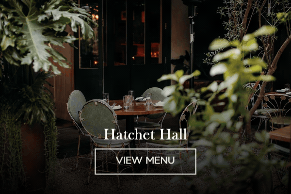 Animated image of Hatchet Hall's leafy candlelit patio with bistro chairs, 'Hatchet Hall' and a View Menu button