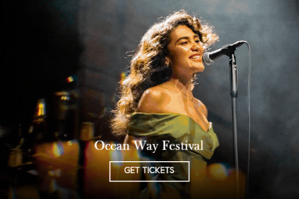 Animated image of a singer performing at a microphone on a smoky stage, 'Ocean Way Festival' with a Get Tickets button