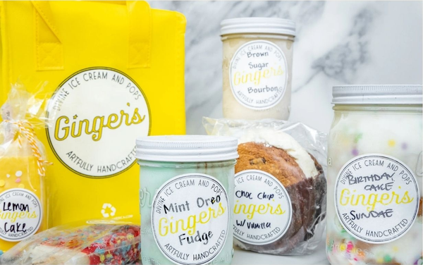 Jars of Ginger's Divine Ice Cream (Mint Oreo Fudge, Brown Sugar Bourbon, Birthday Cake Sundae) beside a yellow Ginger's tote