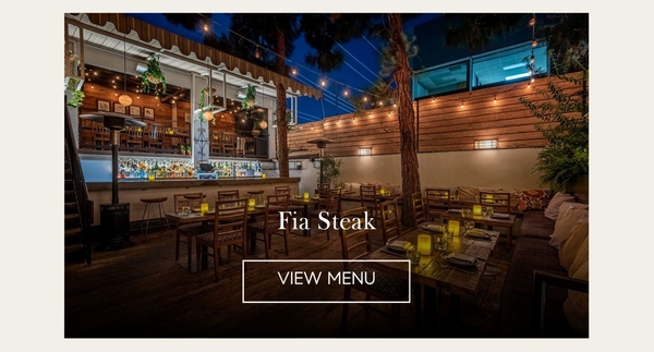 Fia Steak's string-lit outdoor patio and bar at night