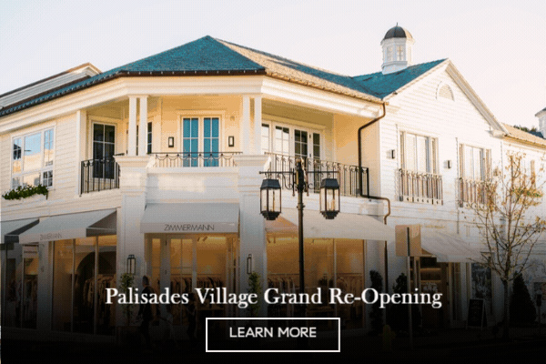 Animated image of a white clapboard Palisades Village building with balconies and storefront awnings, 'Palisades Village Grand Re-Opening' with a Learn More button