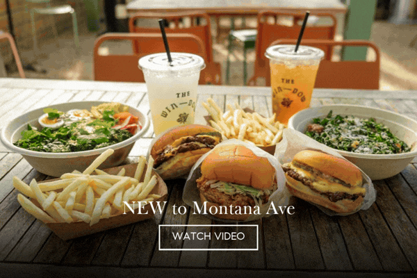 Animated image of The Win-Dow burgers, fries, salads and drinks on an outdoor table, 'NEW to Montana Ave' with a Watch Video button